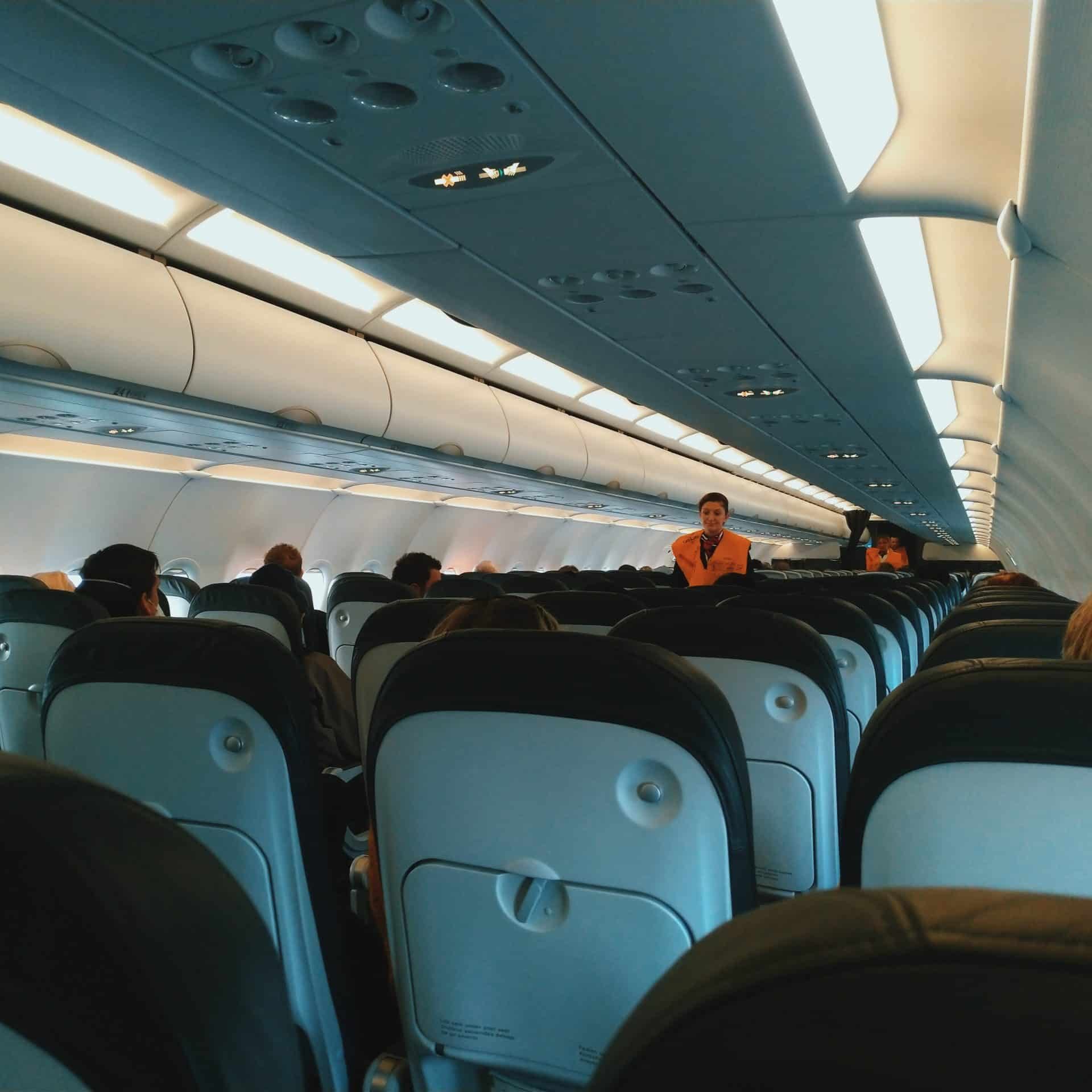 Cabin service crew cleaning aircraft interior, highlighting essential support roles in careers in aviation