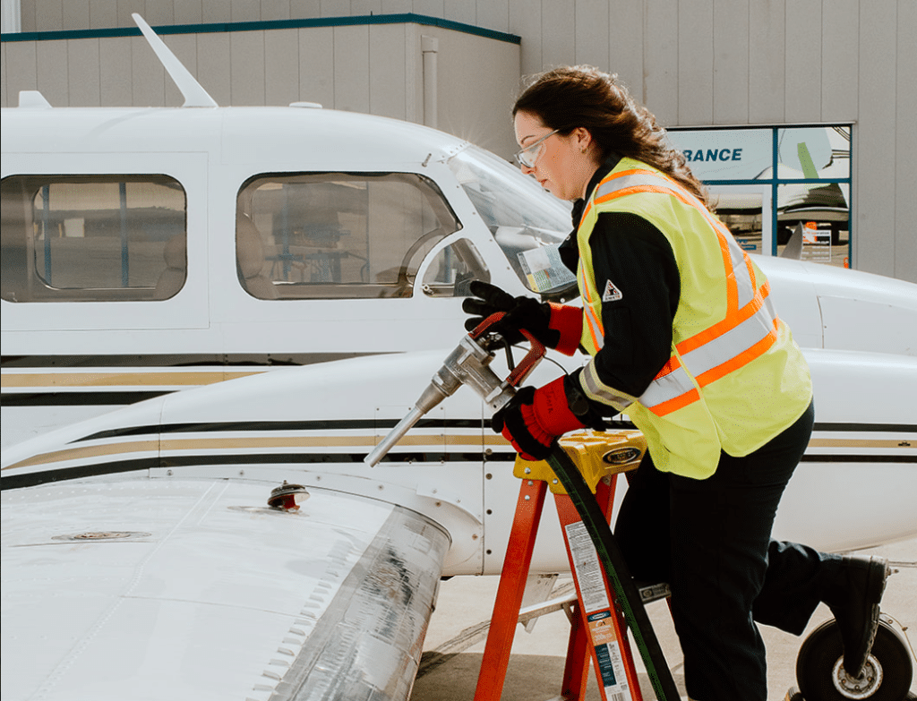 woman fuelling up an aircraft as an aircraft fueler.