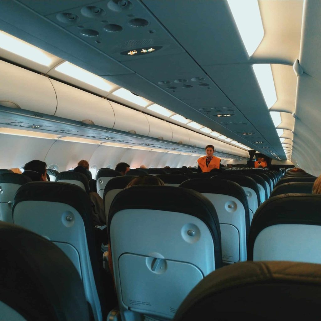Cabin service crew cleaning aircraft interior, highlighting essential support roles in careers in aviation